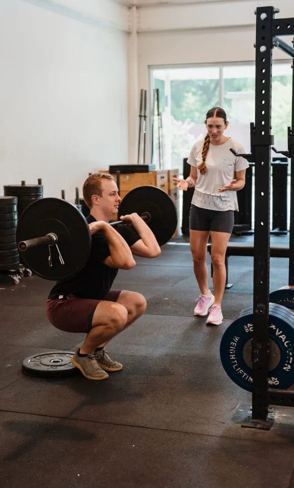 Man training with dumbbell at The Tribe