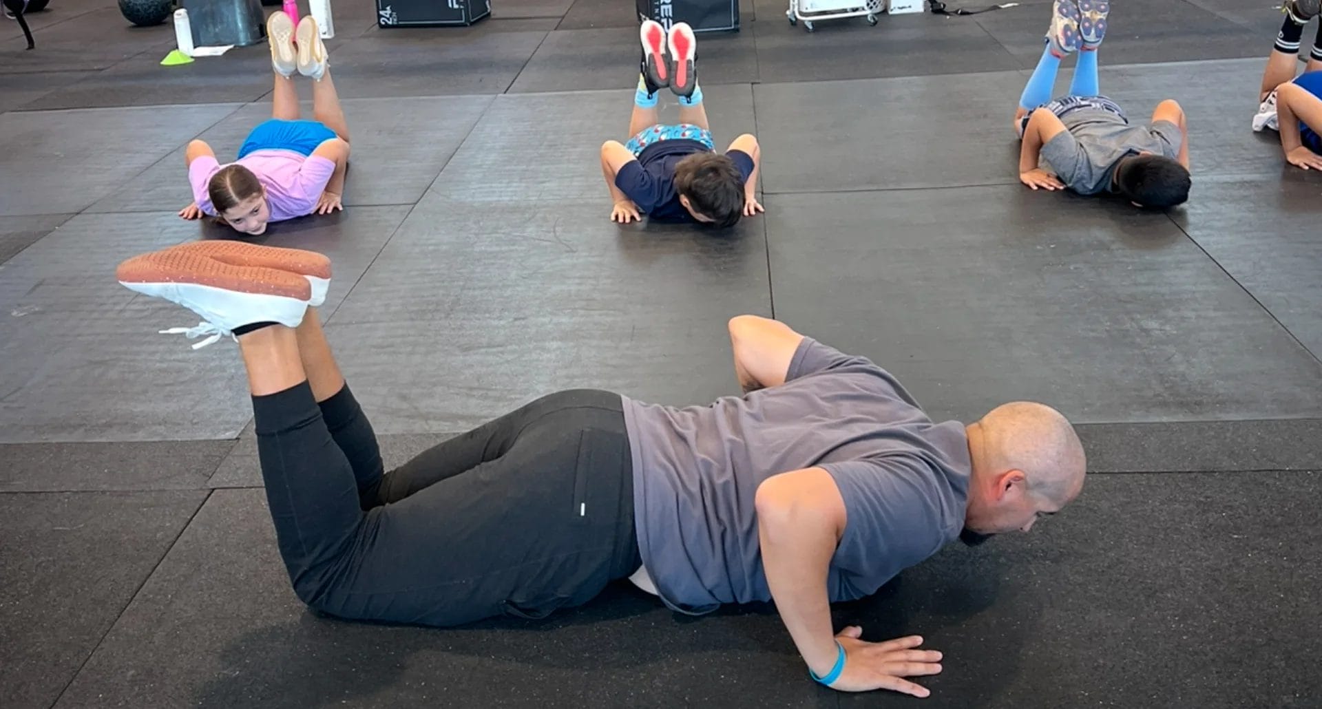 Kids do push ups at The Tribe